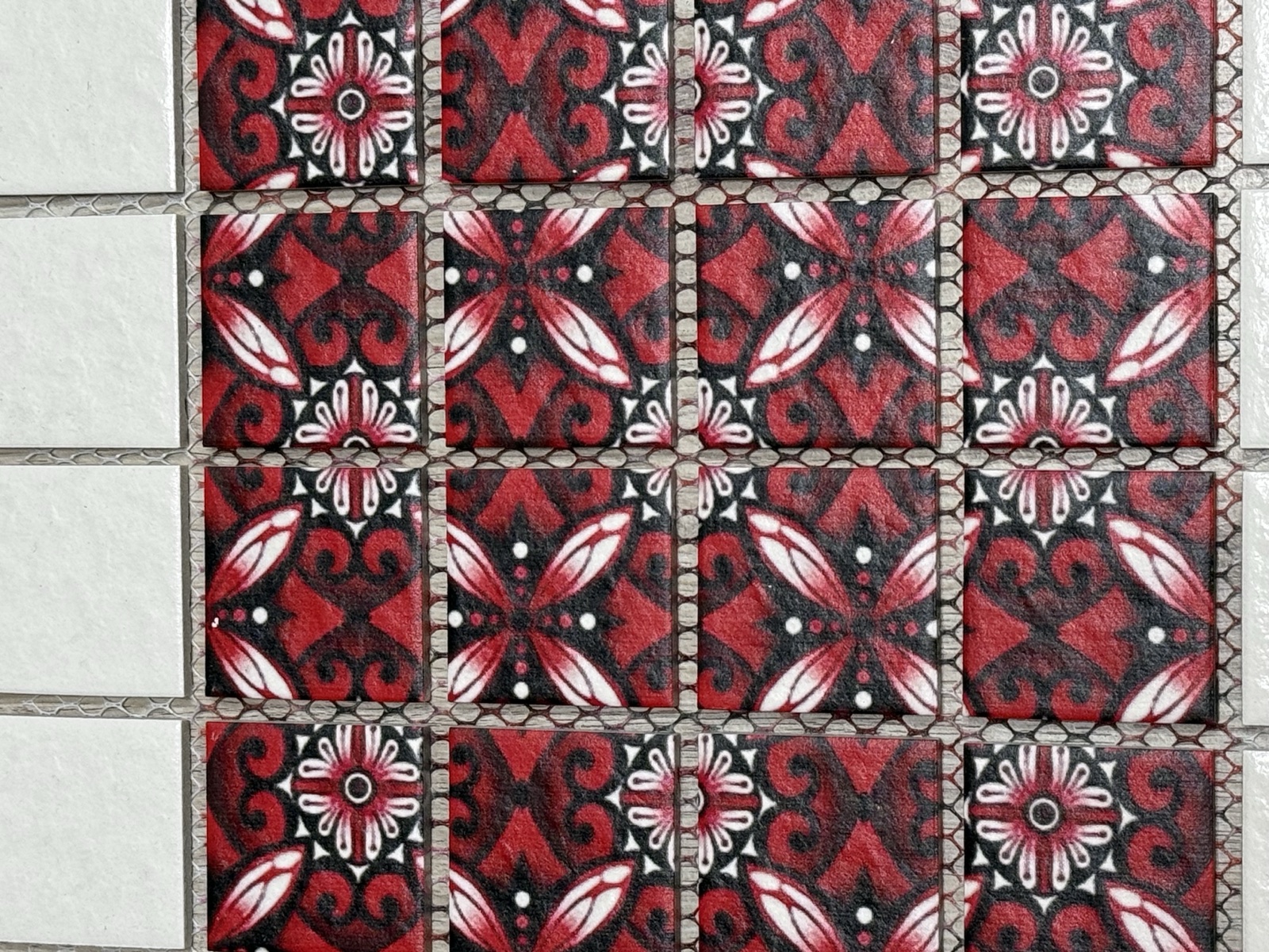 Close view of the red and black pattern printed across individual tiles